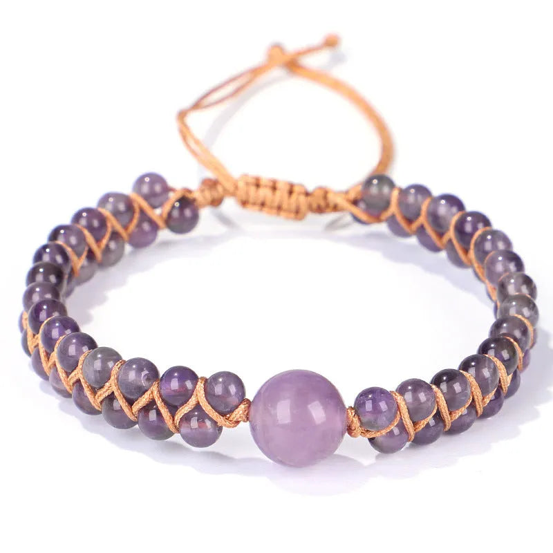 Handmade geometric pull bracelet woven from blue tigereye stone beads on a wrist.