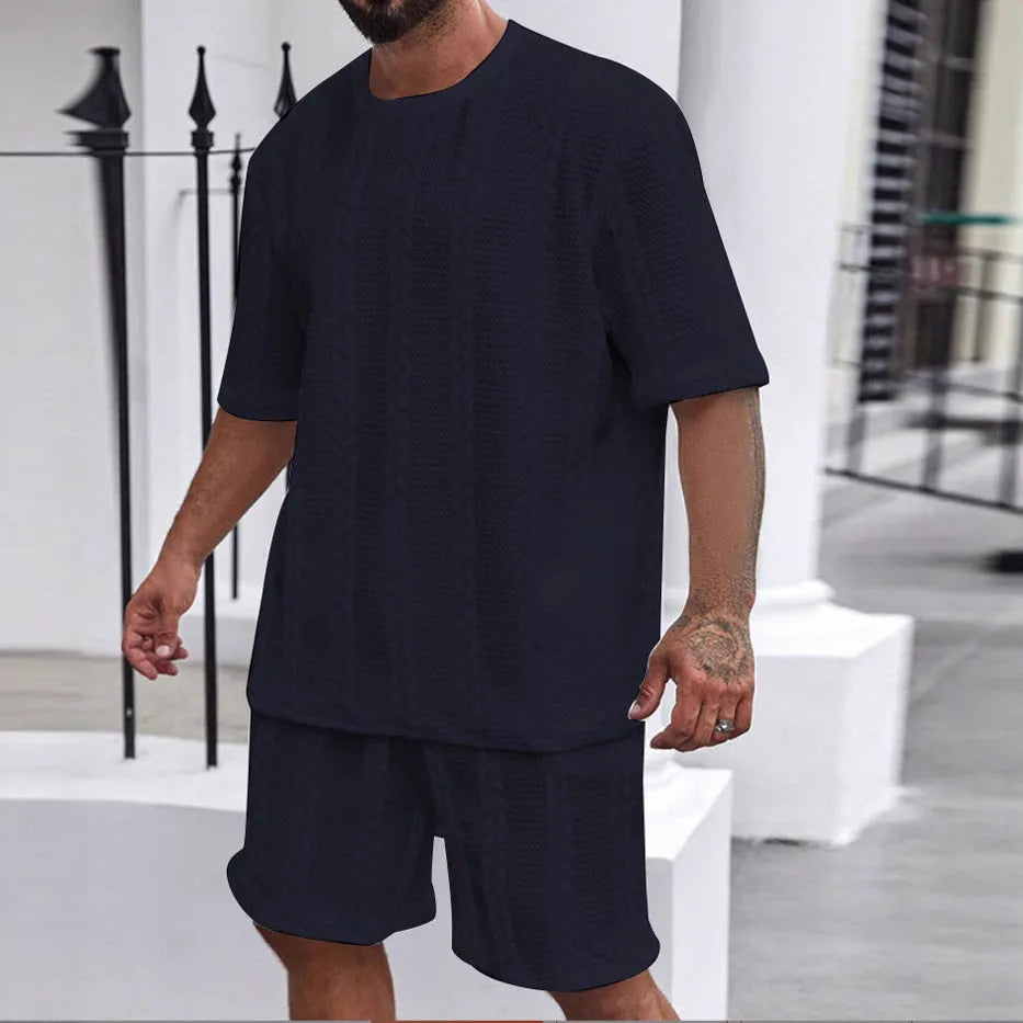 Knitted short-sleeve pullover and matching shorts set in light grey, laid flat.
