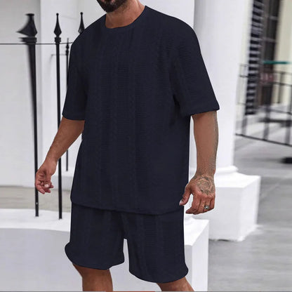 Knitted short-sleeve pullover and matching shorts set in light grey, laid flat.