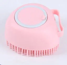 Blue silicone dog bath and massage brush held in a hand.