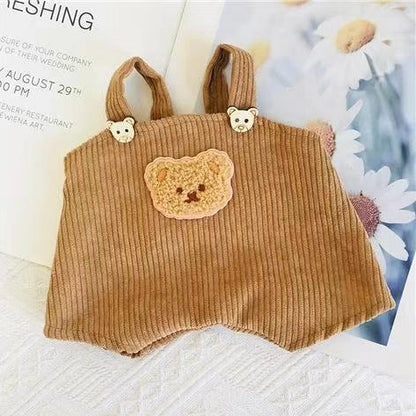 30cm doll clothing collection showing multiple outfit pieces including hooded jackets, sweaters, and suspender pants