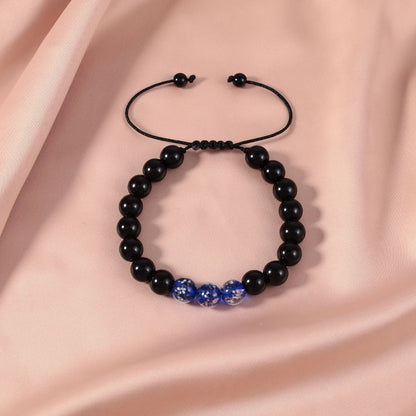 Adjustable bracelet with luminous geometric glass beads in six colour options on a wrist