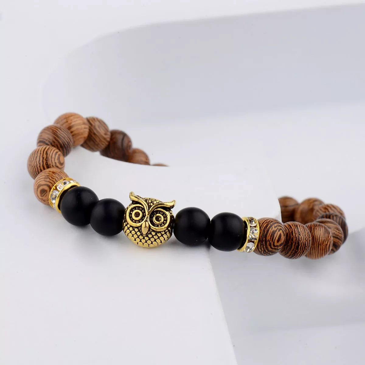 Owl frosted stone lifeline wood grain bracelet in black and gold, featuring wood beads and alloy stone