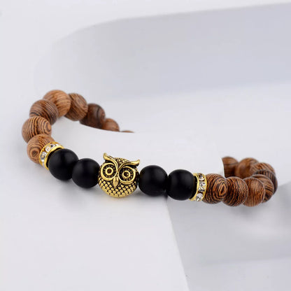 Owl frosted stone lifeline wood grain bracelet in black and gold, featuring wood beads and alloy stone