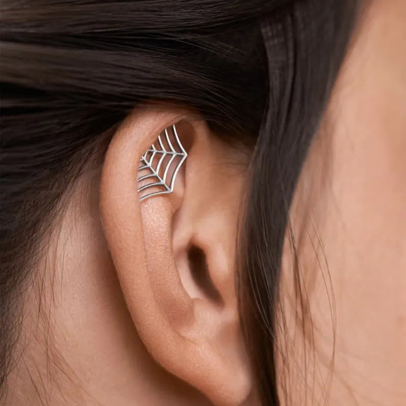 Spider web design stud earrings in gold and silver electroplated metal with geometric mesh pattern