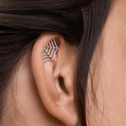 Spider web design stud earrings in gold and silver electroplated metal with geometric mesh pattern
