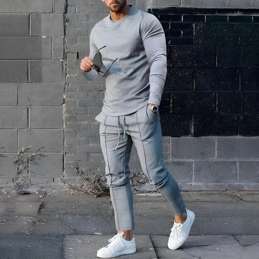 Men's light grey polyester two-piece suit set with long sleeve round neck T-shirt and matching trousers.