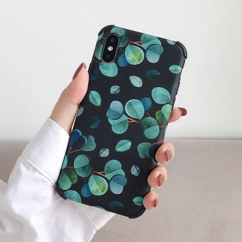 Black silicone iPhone case with a leaf pattern design on the back.
