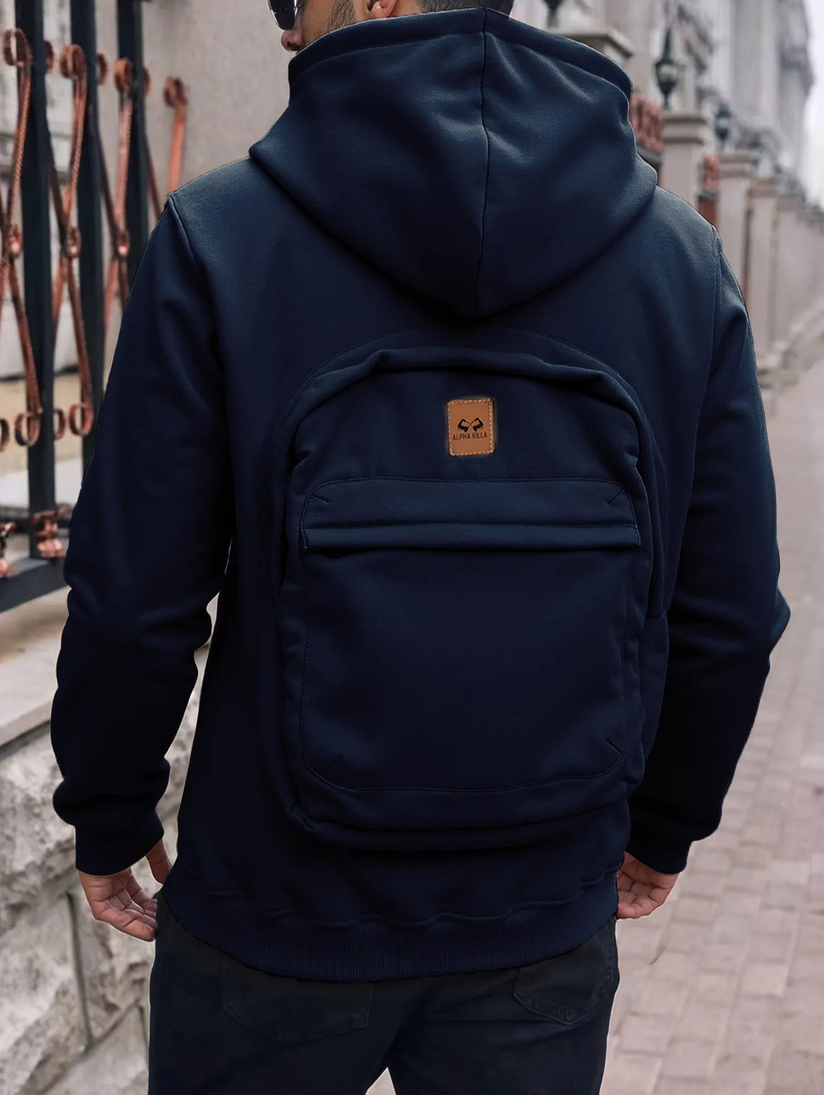 Men's loose-fit hoodie cardigan sweater with back schoolbag design and stick pocket in light grey, black and blue.