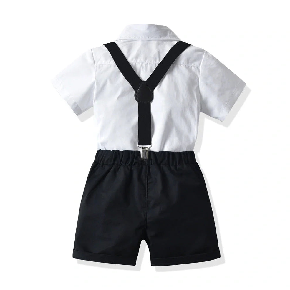 Boys' white short-sleeved shirt with suspender shorts set showing single-breasted closure and adjustable straps