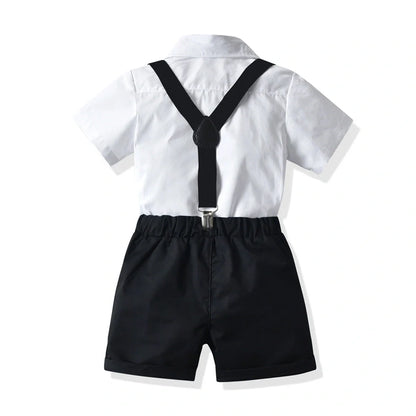 Boys' white short-sleeved shirt with suspender shorts set showing single-breasted closure and adjustable straps
