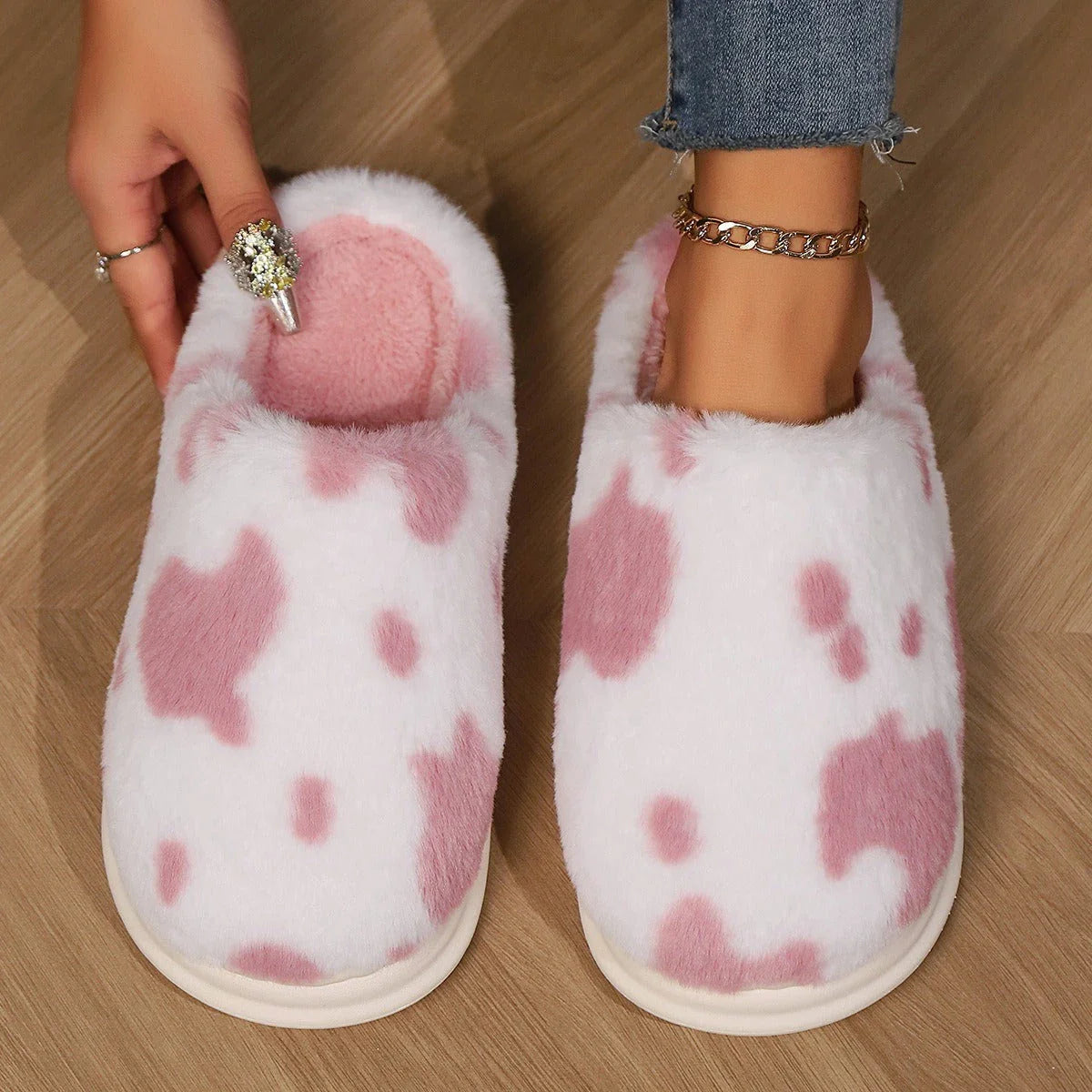 Cozy plush cow-print slippers with non-slip soles for comfortable indoor wear