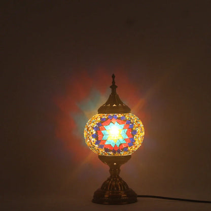 Glass table lamp with 150mm diameter shade and 330cm cord on wooden surface