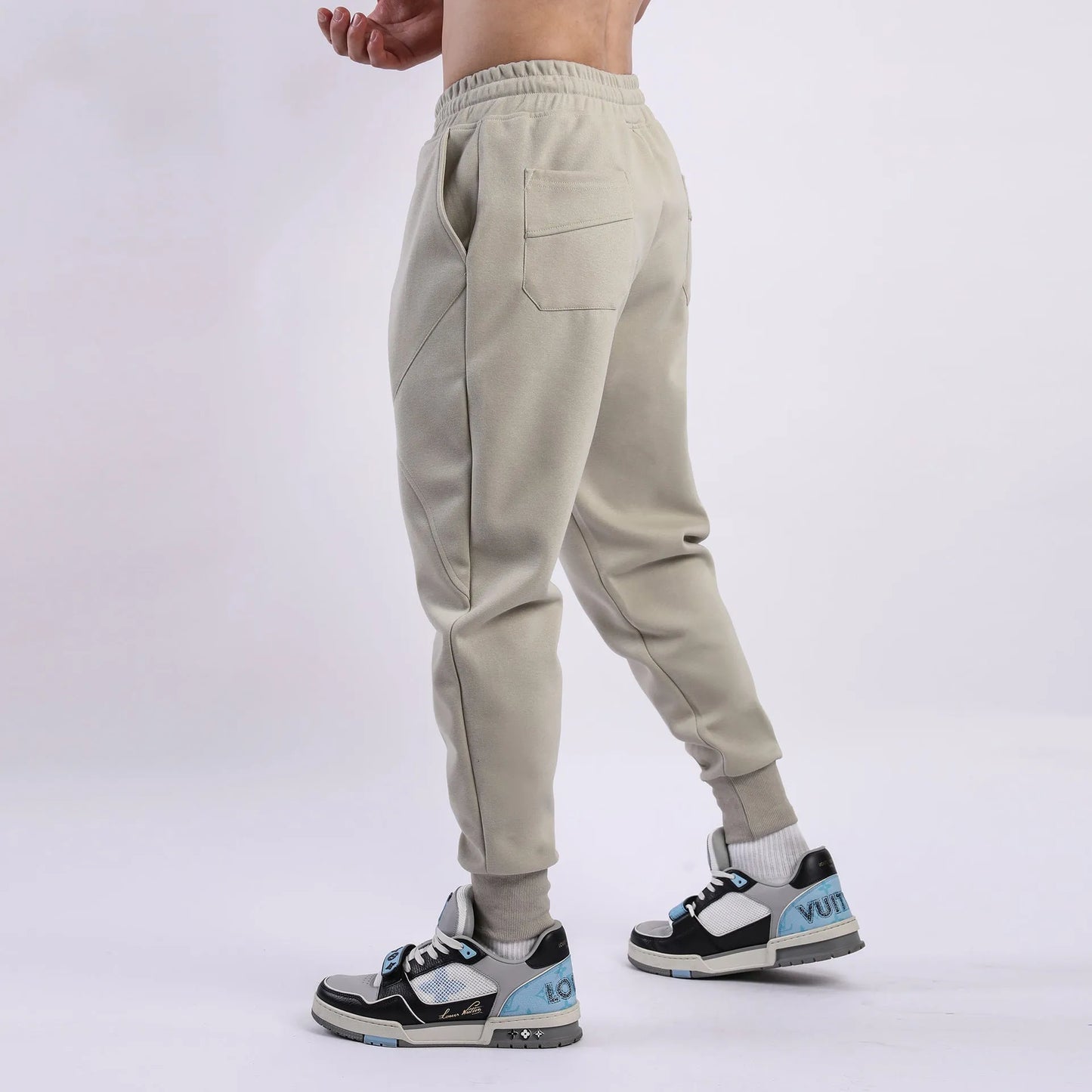 Men's casual trousers with drawstring ankle ties in polyester cotton fabric