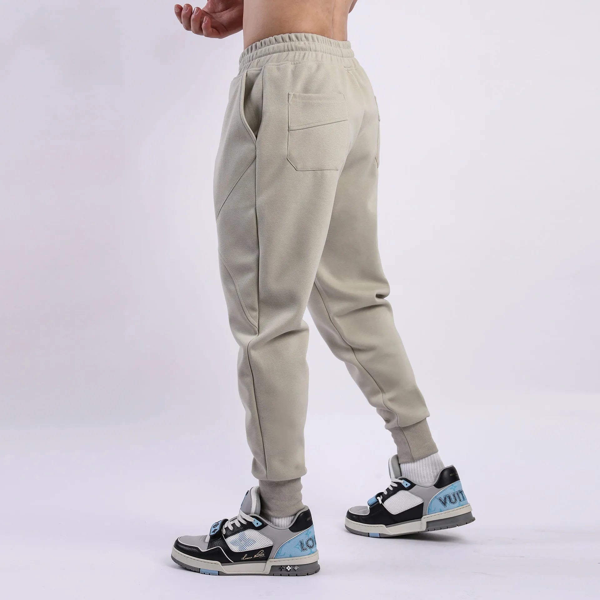 Men's casual trousers with drawstring ankle ties in polyester cotton fabric