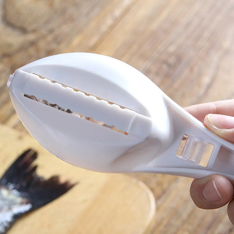Fish scaler with fish-shaped handle and integrated scale cover for kitchen fish preparation