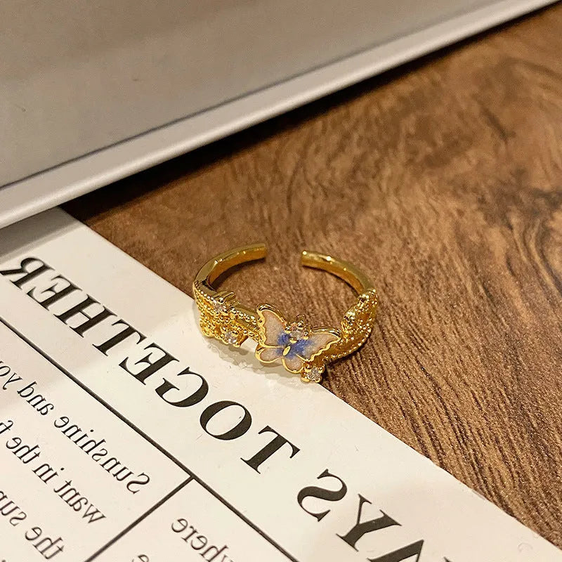 Copper women's ring with Chinese butterfly design and adjustable open loop.