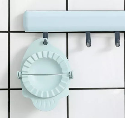 Plastic dumpling maker device in blue, green, and white for quick, uniform dumplings