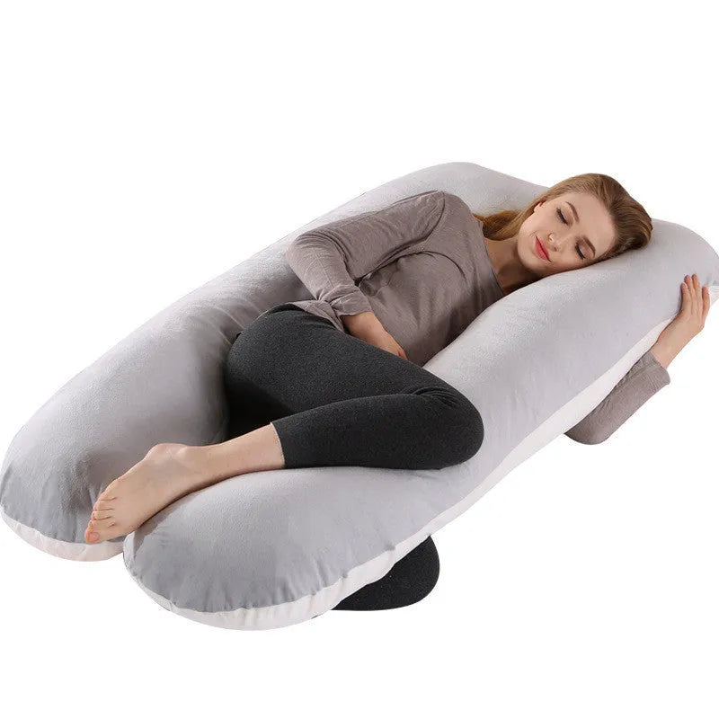 Large U-shaped pregnancy support pillow with removable cover and abdominal support belt.