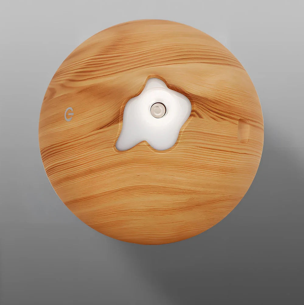 Round wood grain humidifier with USB cable and single mist outlet on light oak finish
