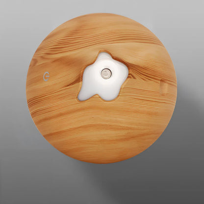 Round wood grain humidifier with USB cable and single mist outlet on light oak finish
