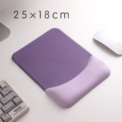 Square cloth mouse pad with grey silicone gel wrist rest and hand pillow on a wooden desk.