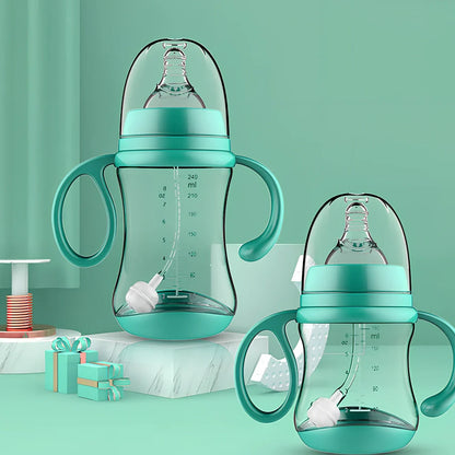 Baby feeding bottle with curved double handles in blue or pink, showing wide caliber opening and transparent PP construction