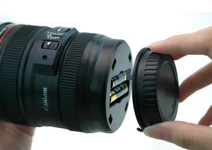 Self-stirring camera lens mug with stainless steel construction and automatic mixing button
