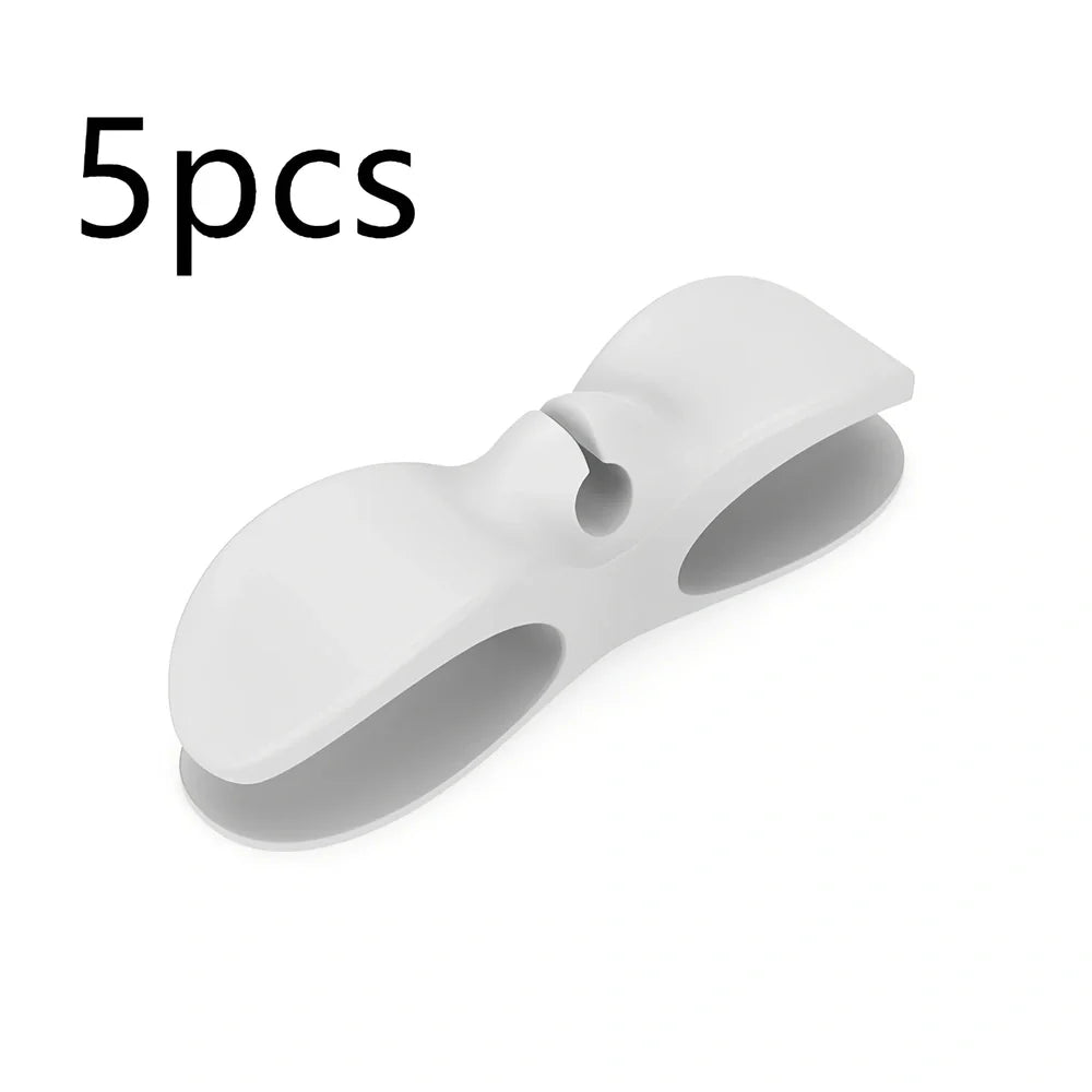 Black TPU cable organizer clips winding appliance cords on kitchen counter, 5cm size, non-marking adhesive for tidy management