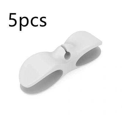 Black TPU cable organizer clips winding appliance cords on kitchen counter, 5cm size, non-marking adhesive for tidy management