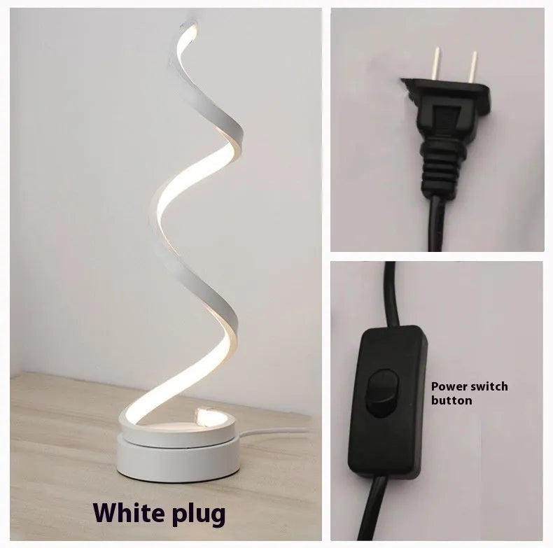 Black and white minimalist LED bedside lamp with aluminium shade and tri-colour dimming on a table