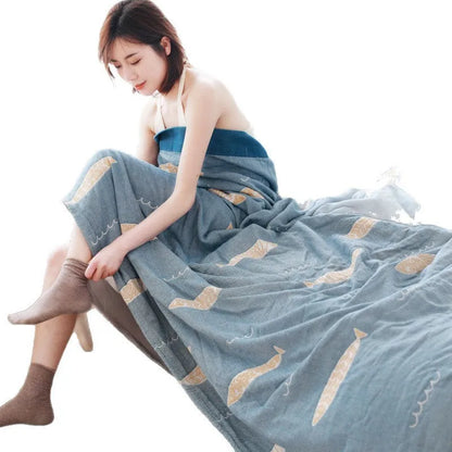 Pure cotton five-layer gauze bedspread blanket in Roulette Wheel Blue pattern on a bed.