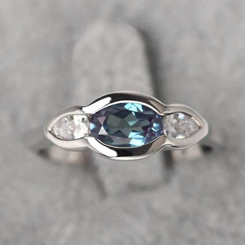 Women's geometric ellipse copper ring with inlaid zircon in white gold colour, showing distinctive non-circular shape
