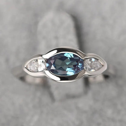 Women's geometric ellipse copper ring with inlaid zircon in white gold colour, showing distinctive non-circular shape