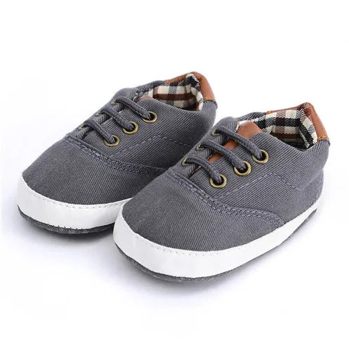 Baby canvas shoes in solid colour with soft bottom and front strap, sizes 11cm to 13cm