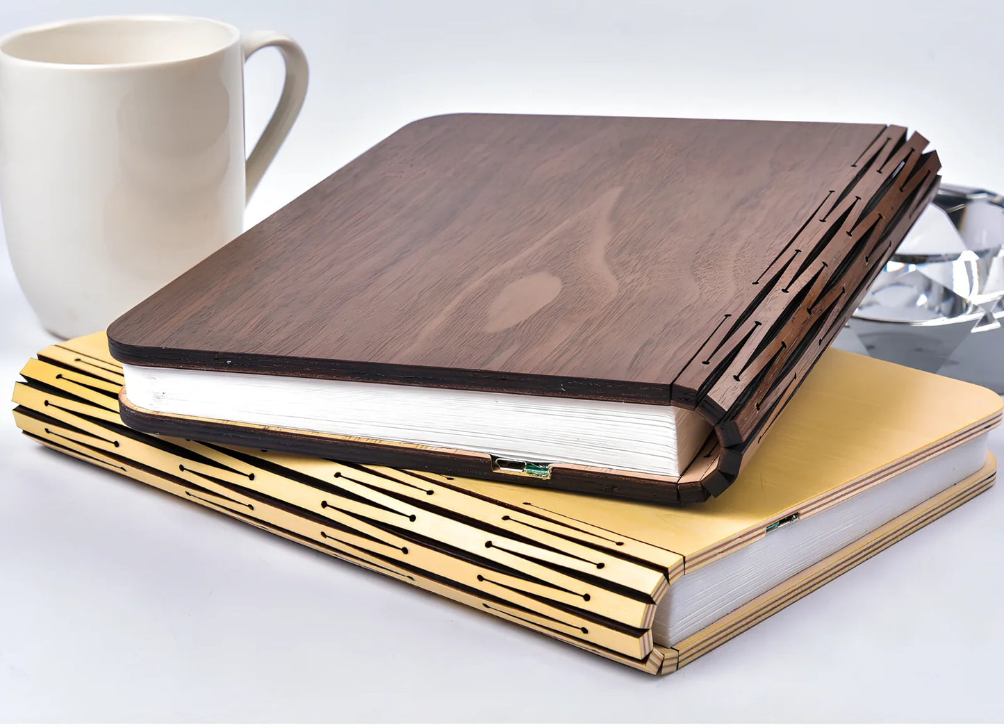 LED book lamp with wooden cover open at angle showing illuminated pages and USB cable