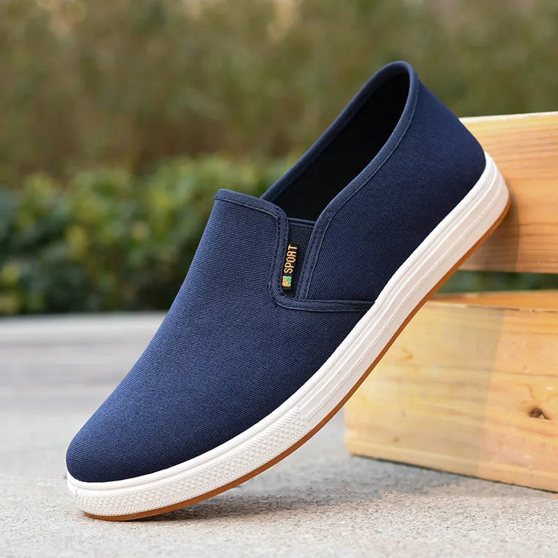Men's low-top slip-on canvas casual shoes in black with a round toe and composite sole.