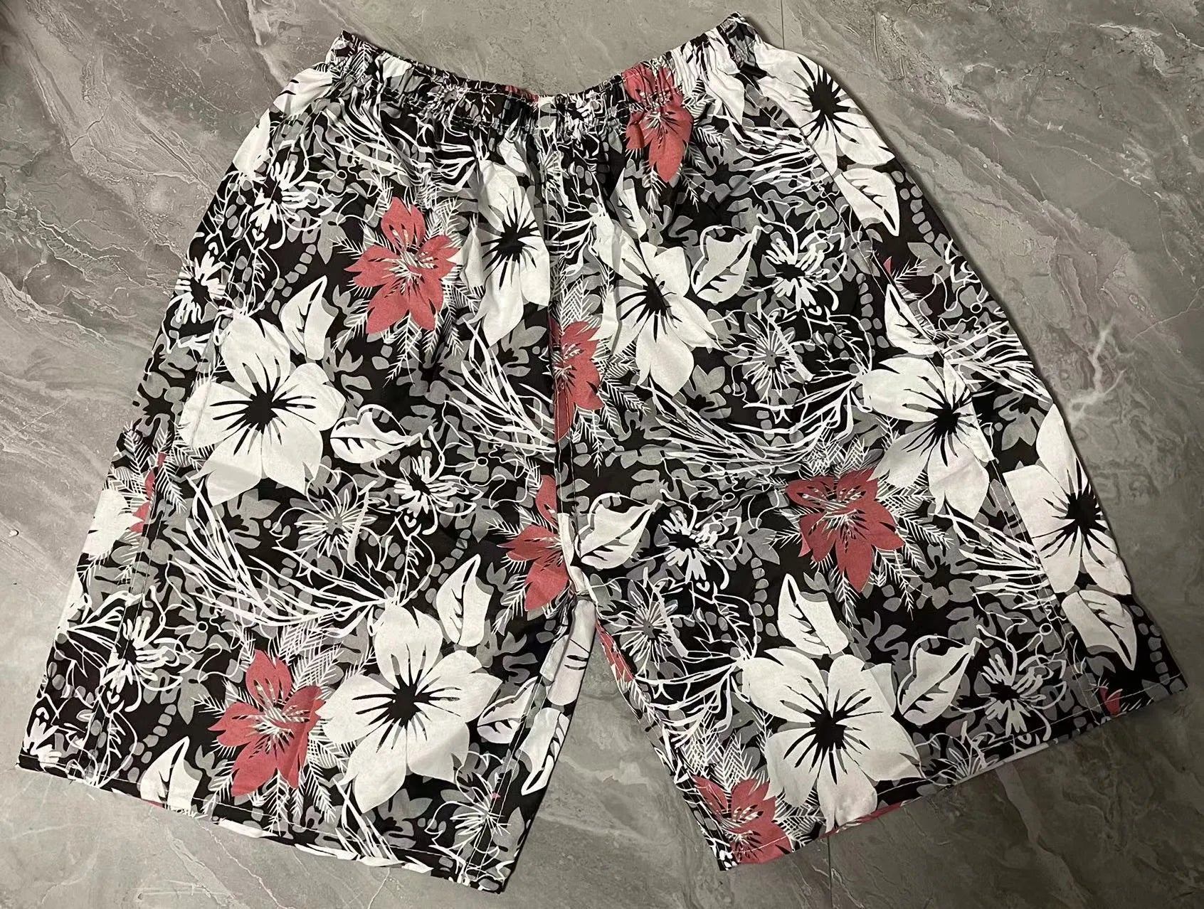 Men's floral printed swimming trunks in polyester fabric showing multiple pattern options for beach and pool use