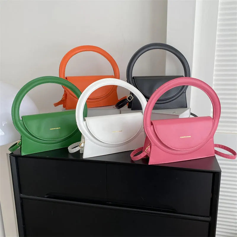 Simple square messenger bag in PU leather with a shoulder strap, shown in various colours.