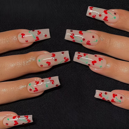 Sheet of 24 red diamond and cherry patterned nail art stickers with a small tube of adhesive glue.