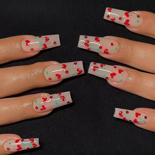 Sheet of 24 red diamond and cherry patterned nail art stickers with a small tube of adhesive glue.