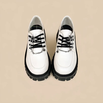 Women's Duke Asterism preppy loafers with a round toe and metal cross shoulder strap.
