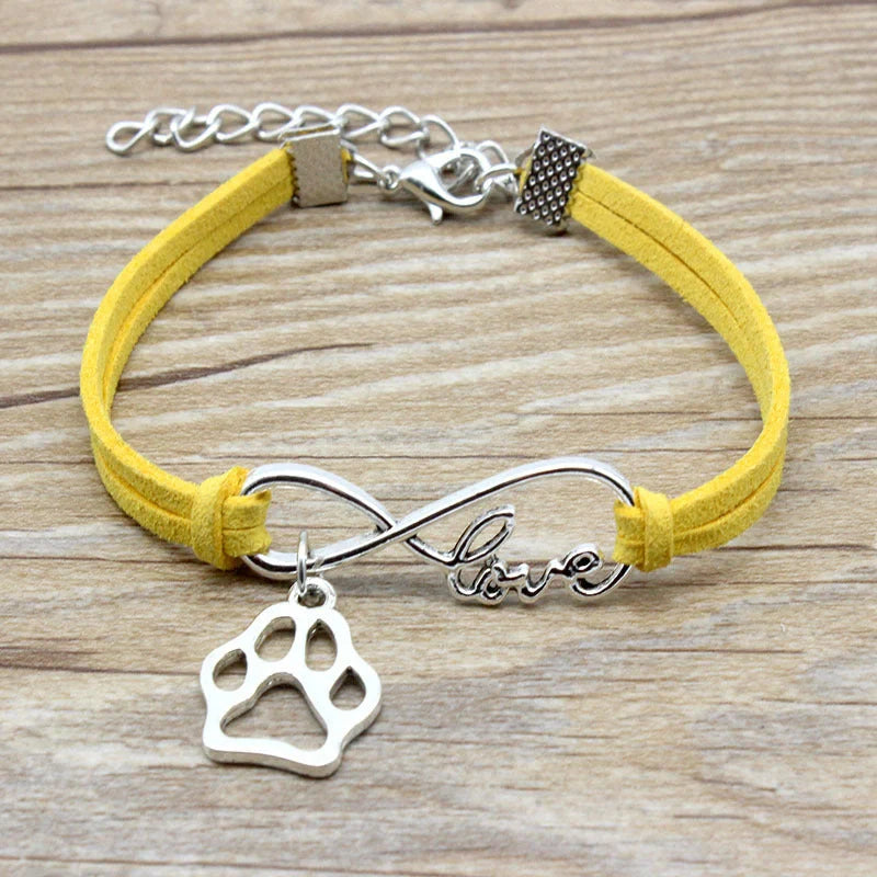 Hand-woven Infinite Love Pet Bracelet in various colors, showcasing the bow shape and alloy material.