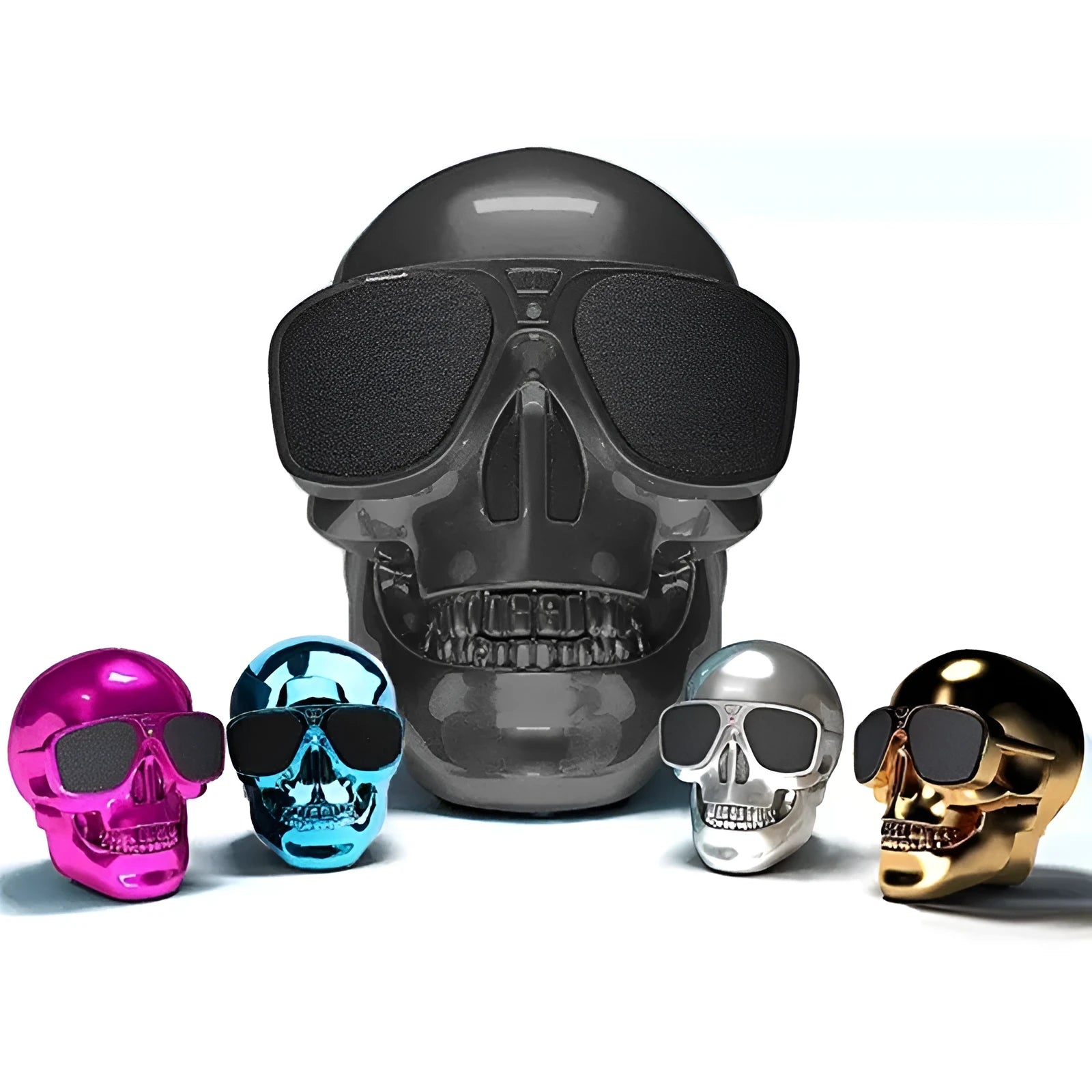 Limited edition Skull-shaped portable wireless Bluetooth speaker in various colours on a table.