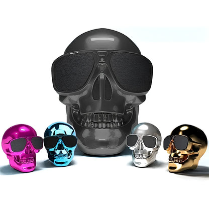 Limited edition Skull-shaped portable wireless Bluetooth speaker in various colours on a table.
