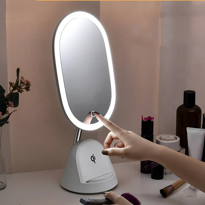 White adjustable LED desk lamp with integrated circular makeup mirror on a desk.