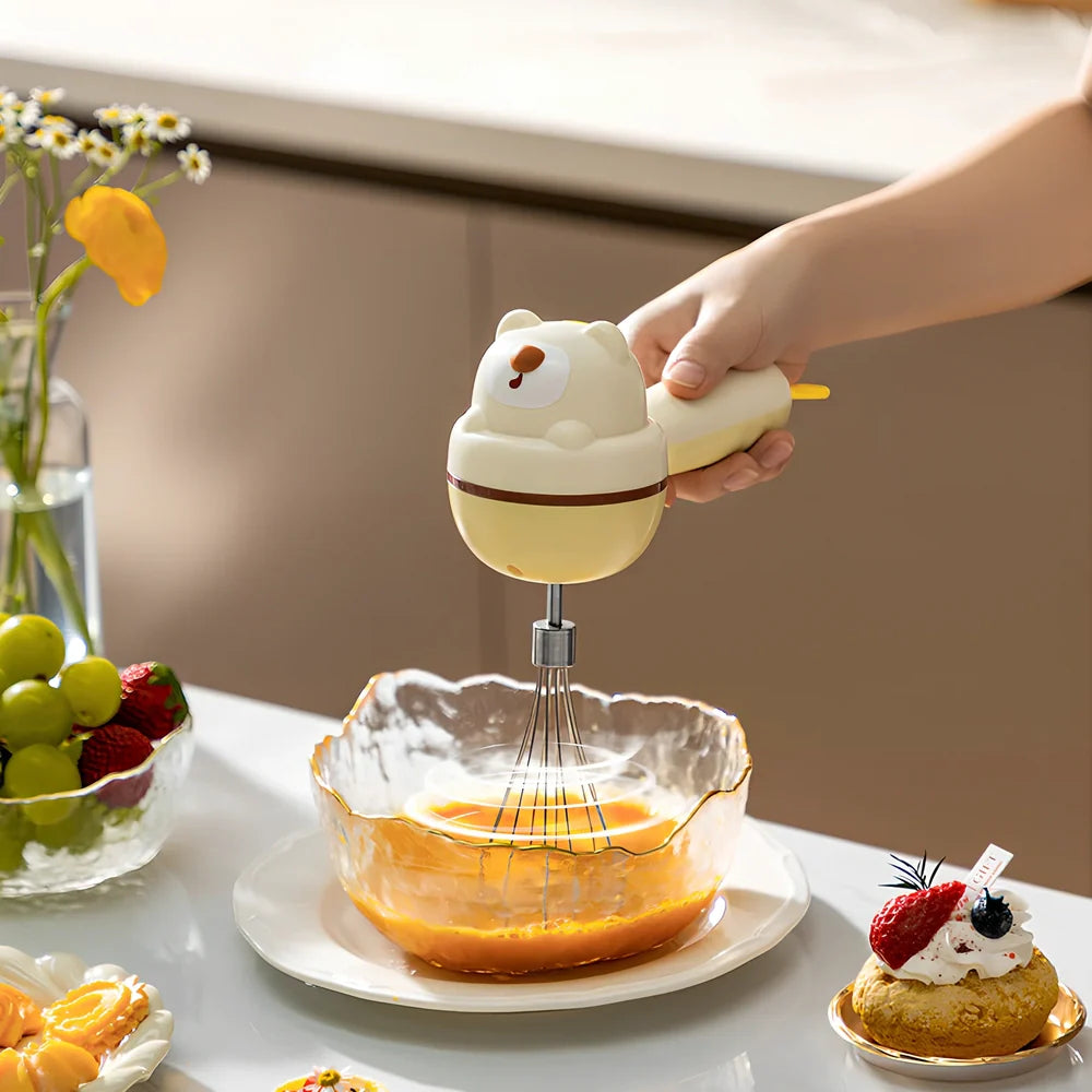 Yellow handheld electric whisk with stainless steel beaters and USB power cable