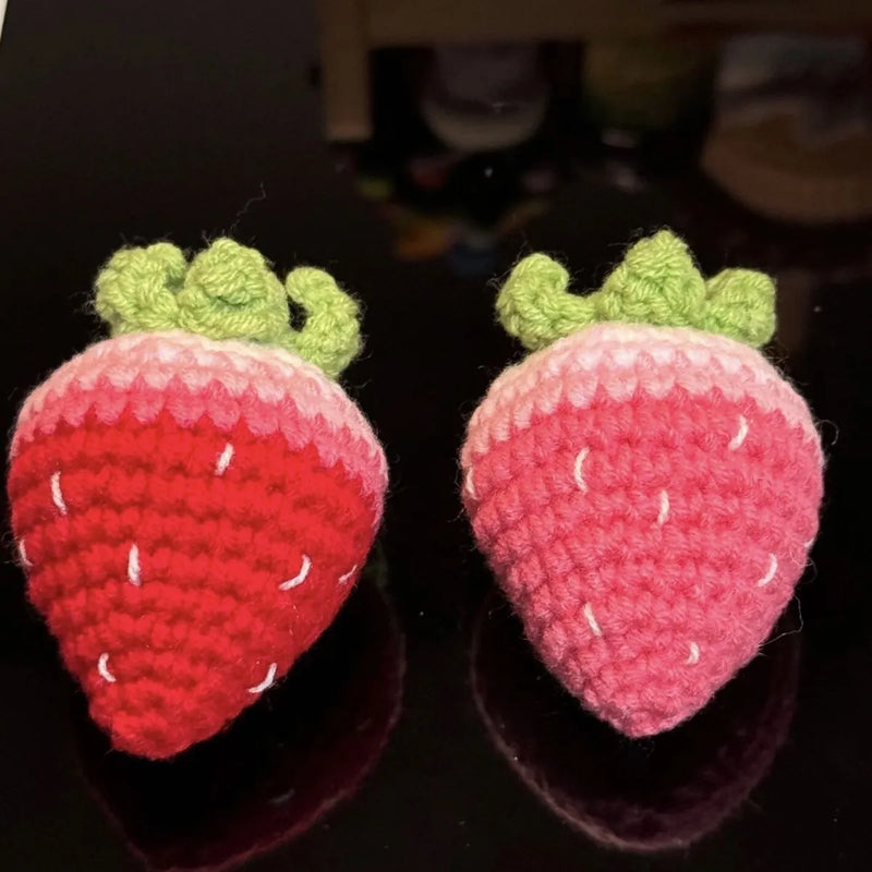 Finished strawberry pendant keychain made from soft plush material in red or pink colours for attaching to keys, bags, or lanyards as a decorative accessory