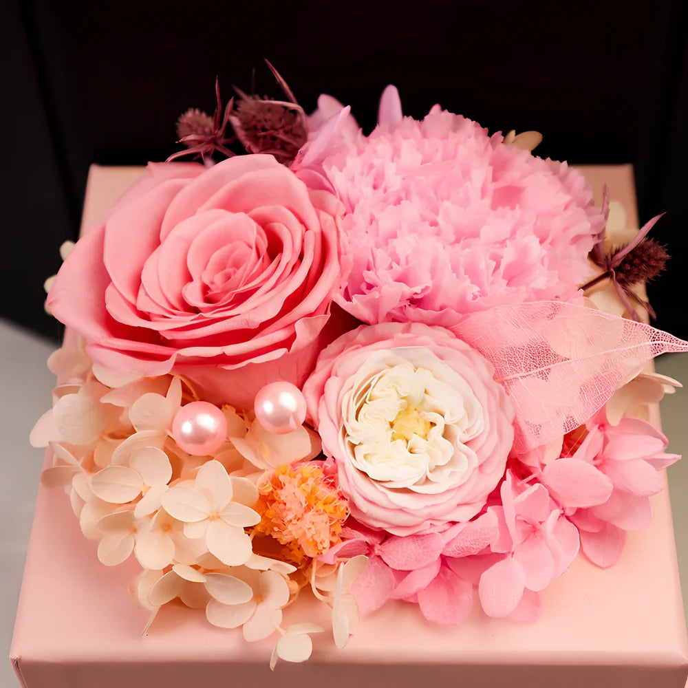 Preserved eternal flower gift box with roses, carnations, and hydrangea in red and pink colours