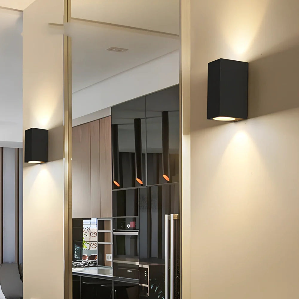 Black aluminium LED wall lamp with tempered glass shade mounted on white wall